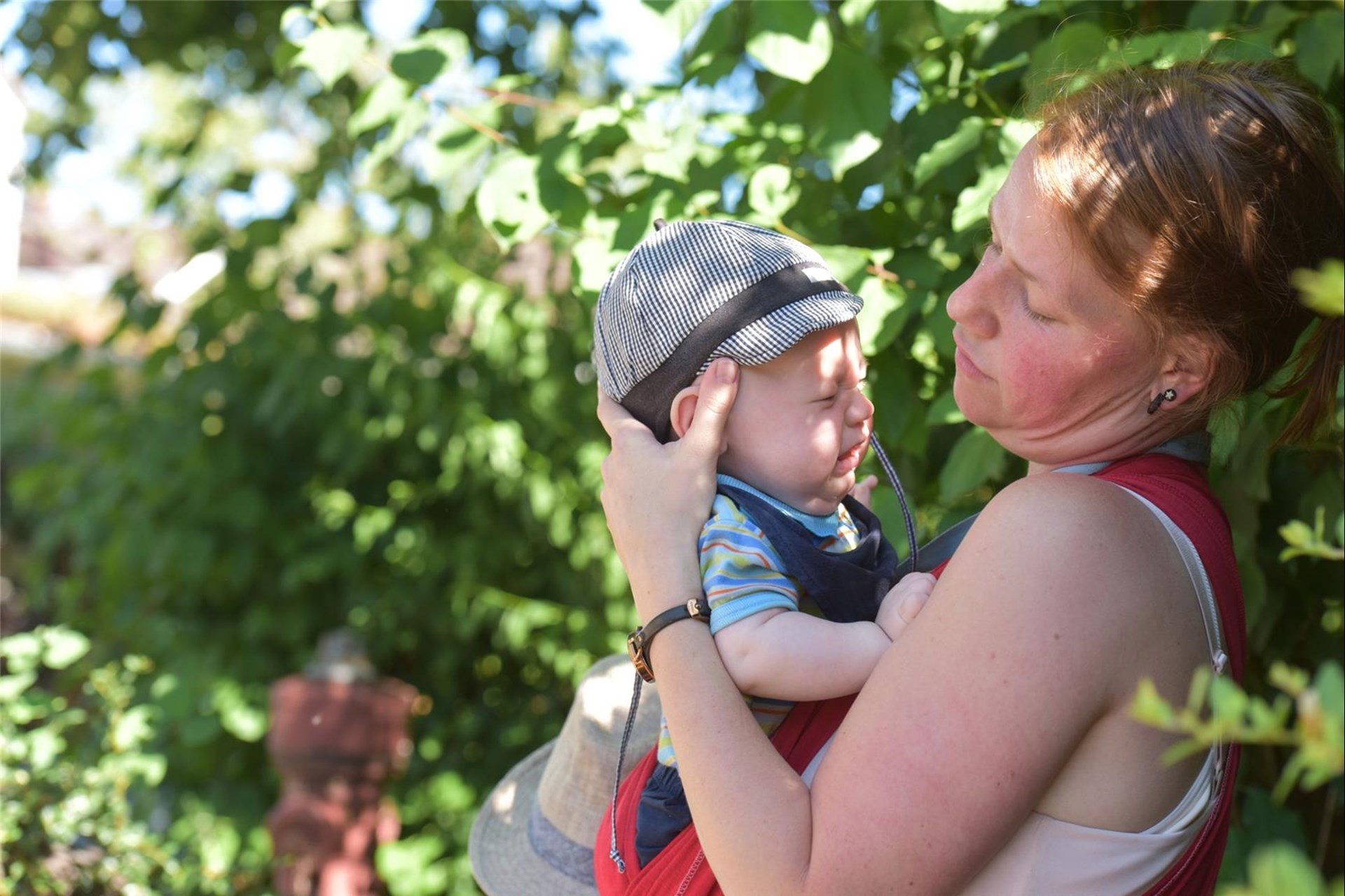 Mutter betrachtet ihr weinendes Baby auf dem Arm