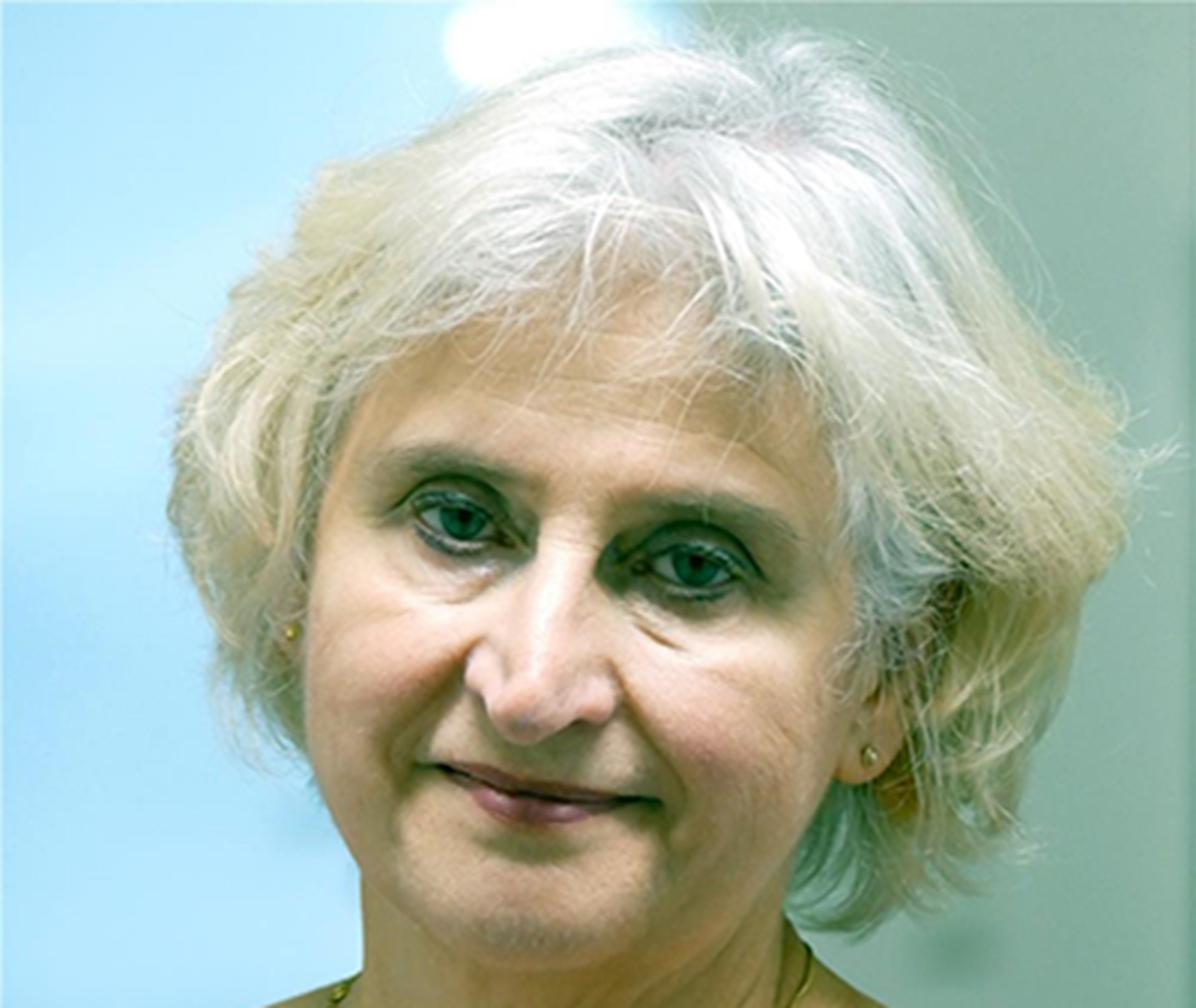 Sanft lächelnde, ältere Frau mit weißen Haaren